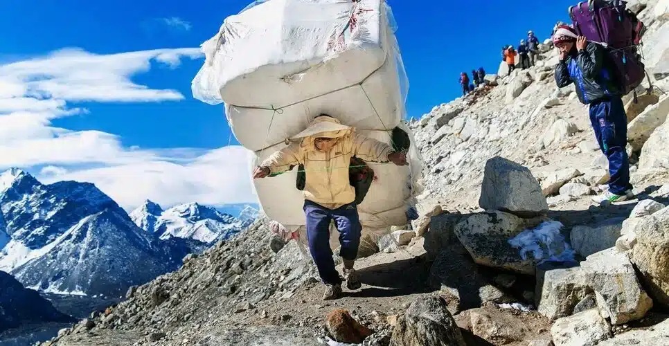A Porter Carrying Loads In Everest Trekking Trail
